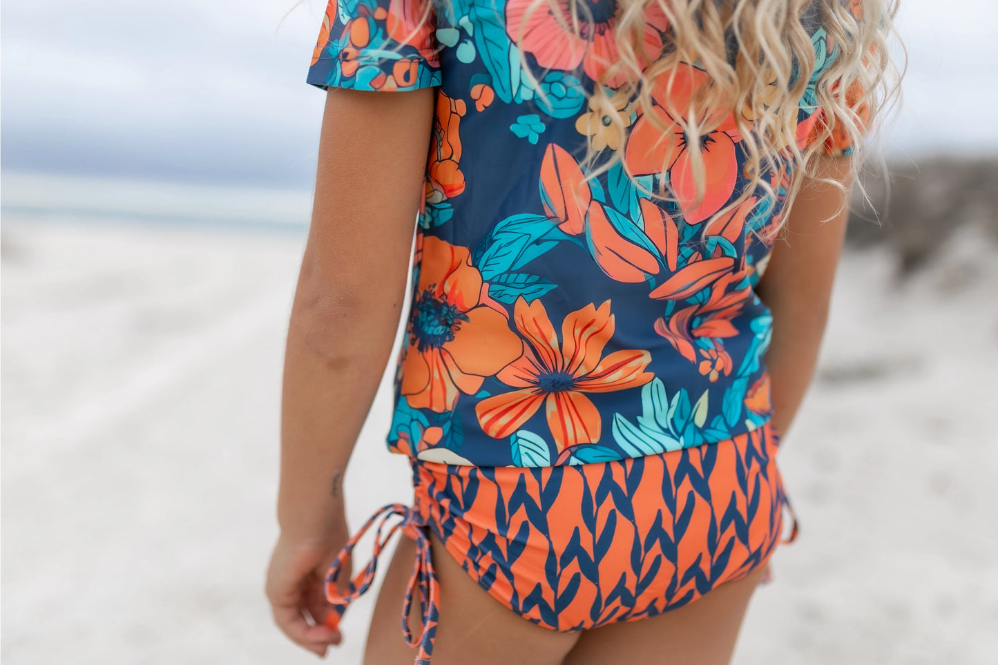 Oopsie Daisy Kid's Navy & Orange Floral Short Sleeve Rash Guard Swimsuit
