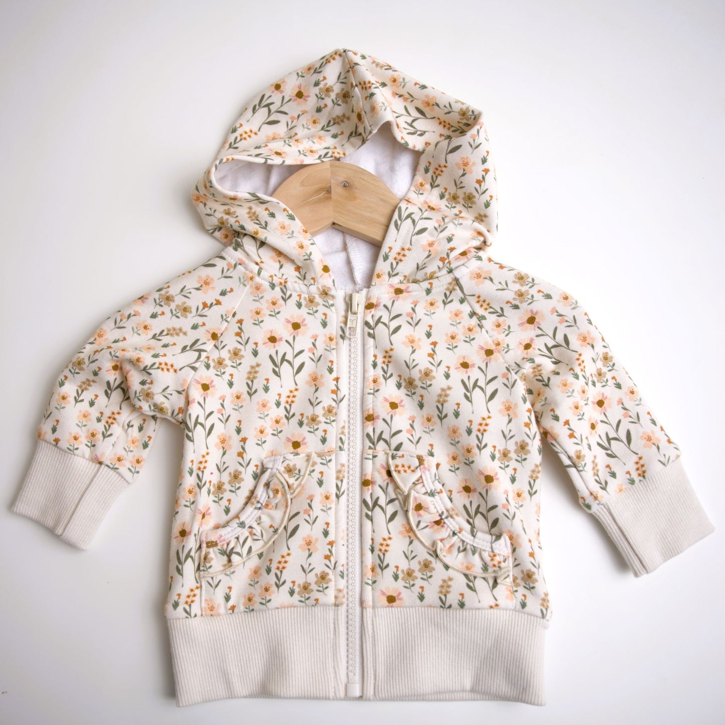 Babysprouts girl's hooded jacket with a floral daisy pattern in various colors primarily in white and pink, with a drawstring hood.