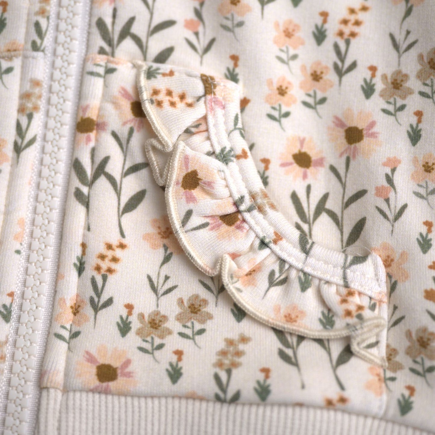Babysprouts girl's hooded jacket with a floral daisy pattern in various colors primarily in white and pink, with a drawstring hood.
