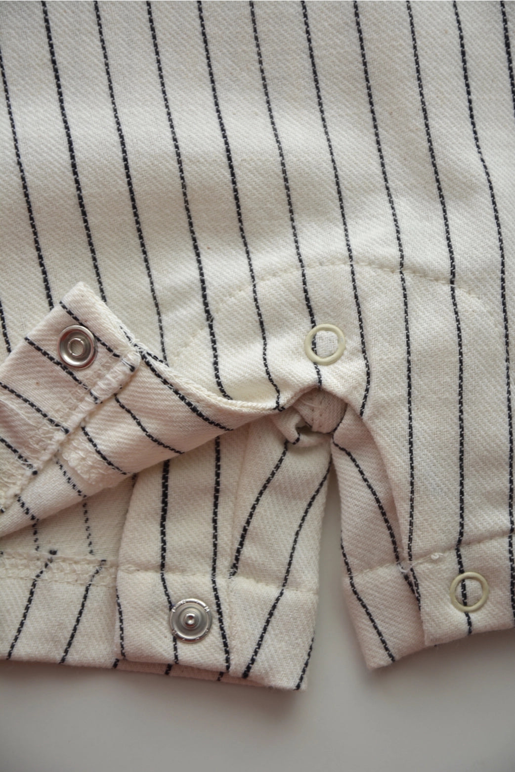 Close up of snaps on Eli & Nev Baby/Kid's Overalls - Emilien/Stripes