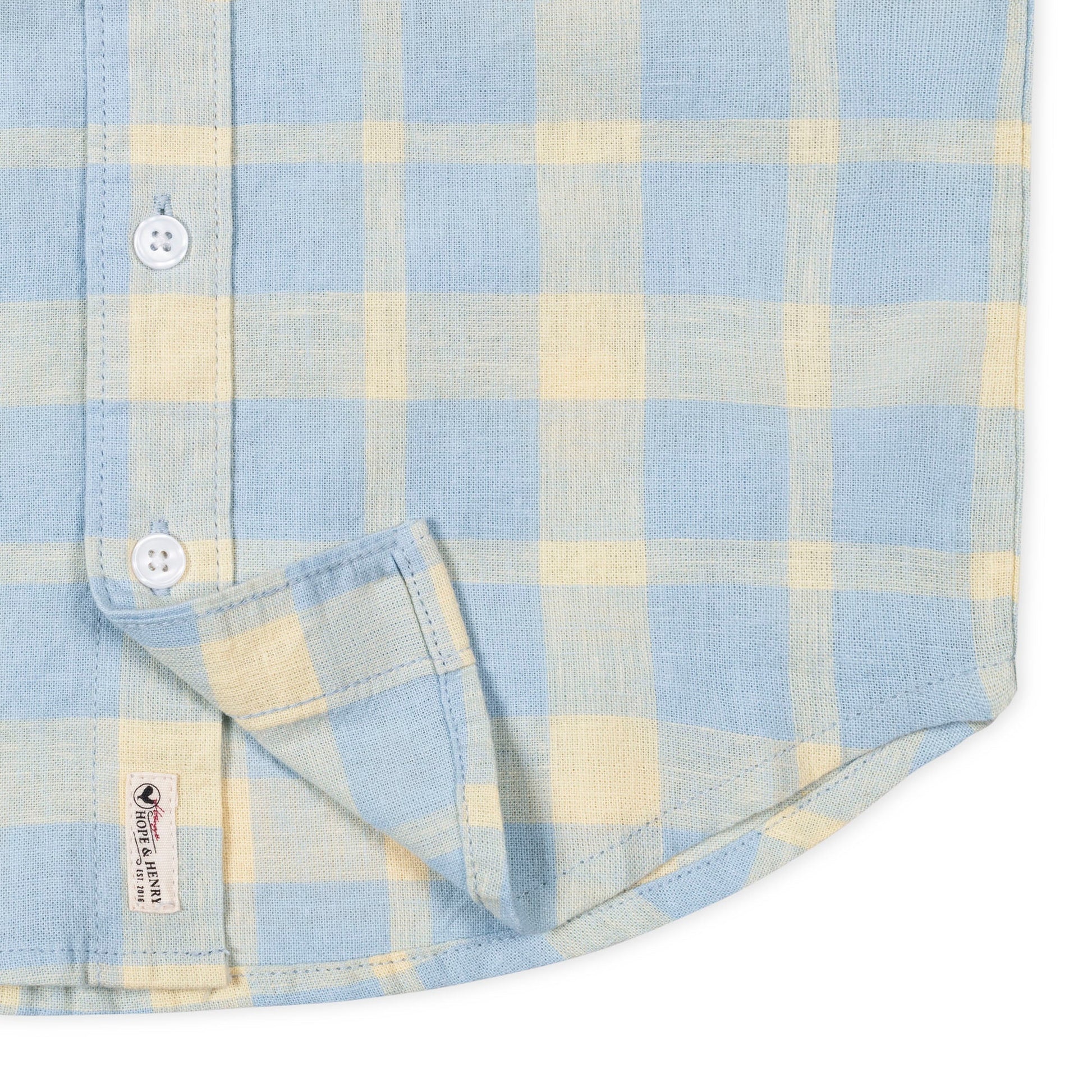 Blue and yellow plaid short sleeve collared shirt on a white background