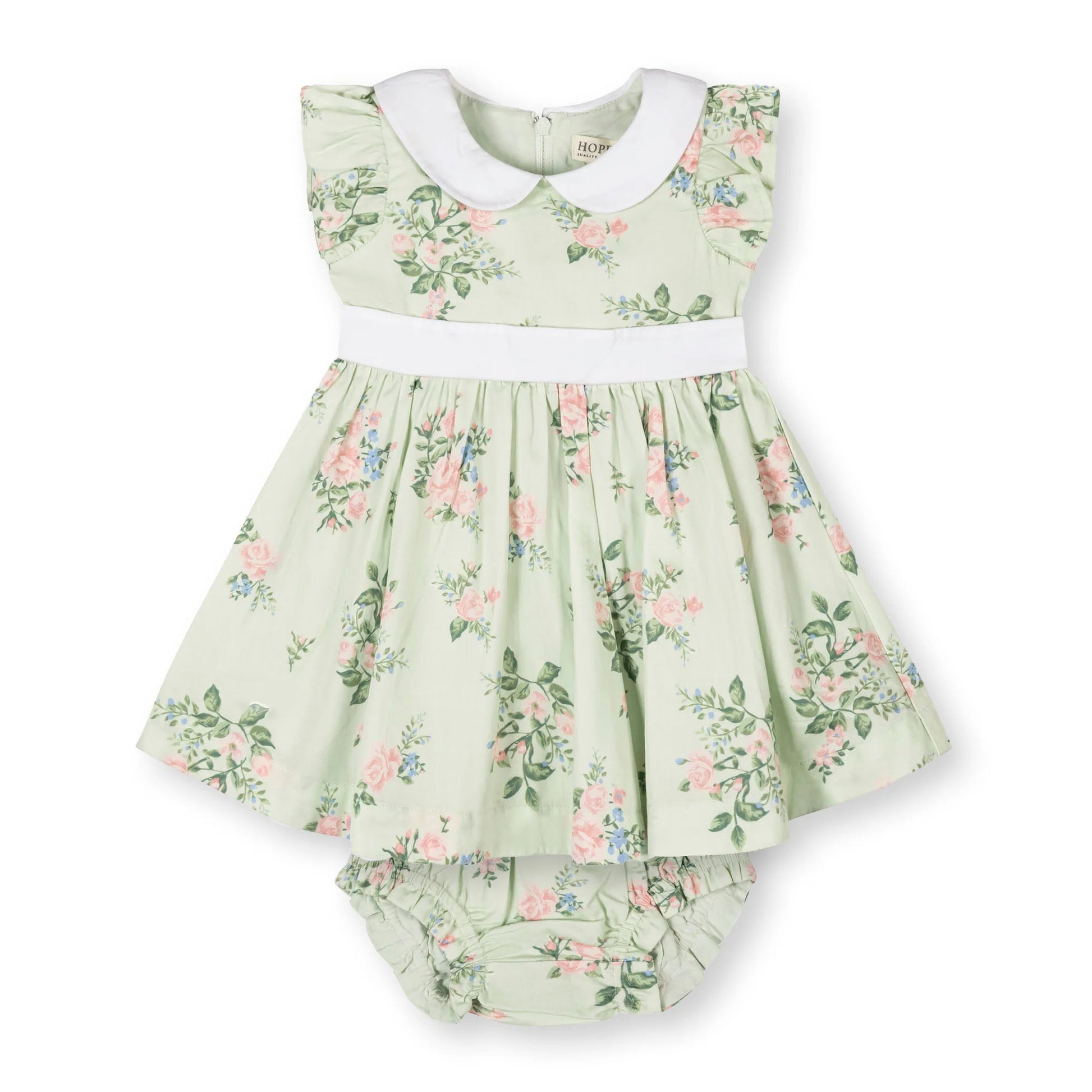 Green floral baby dress with pink and blue floral pattern with white collar on a white background