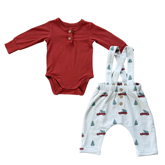 Red baby bodysuit and white overalls with car pattern on a white background