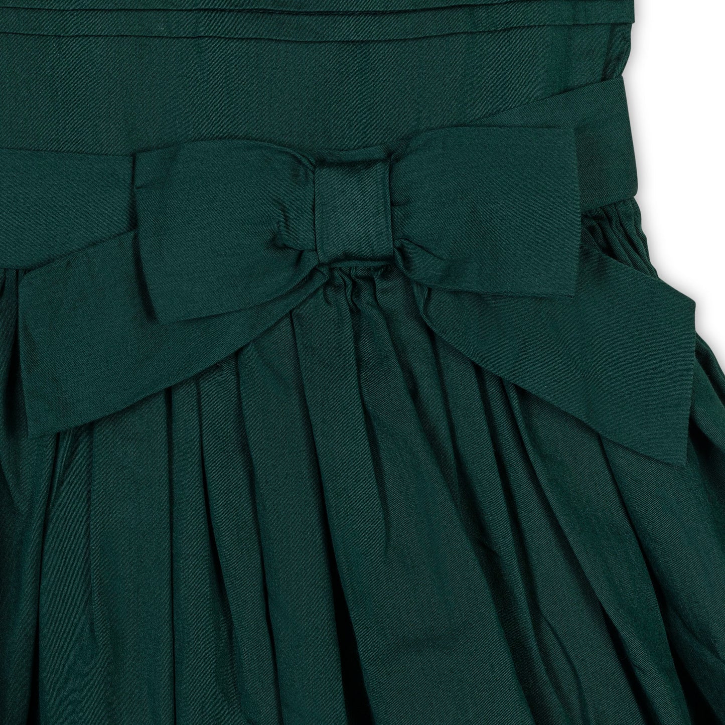 closeup of organic cotton holiday dress with pleated skirt