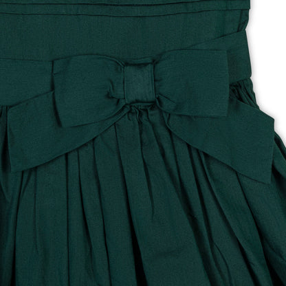 closeup of organic cotton holiday dress with pleated skirt