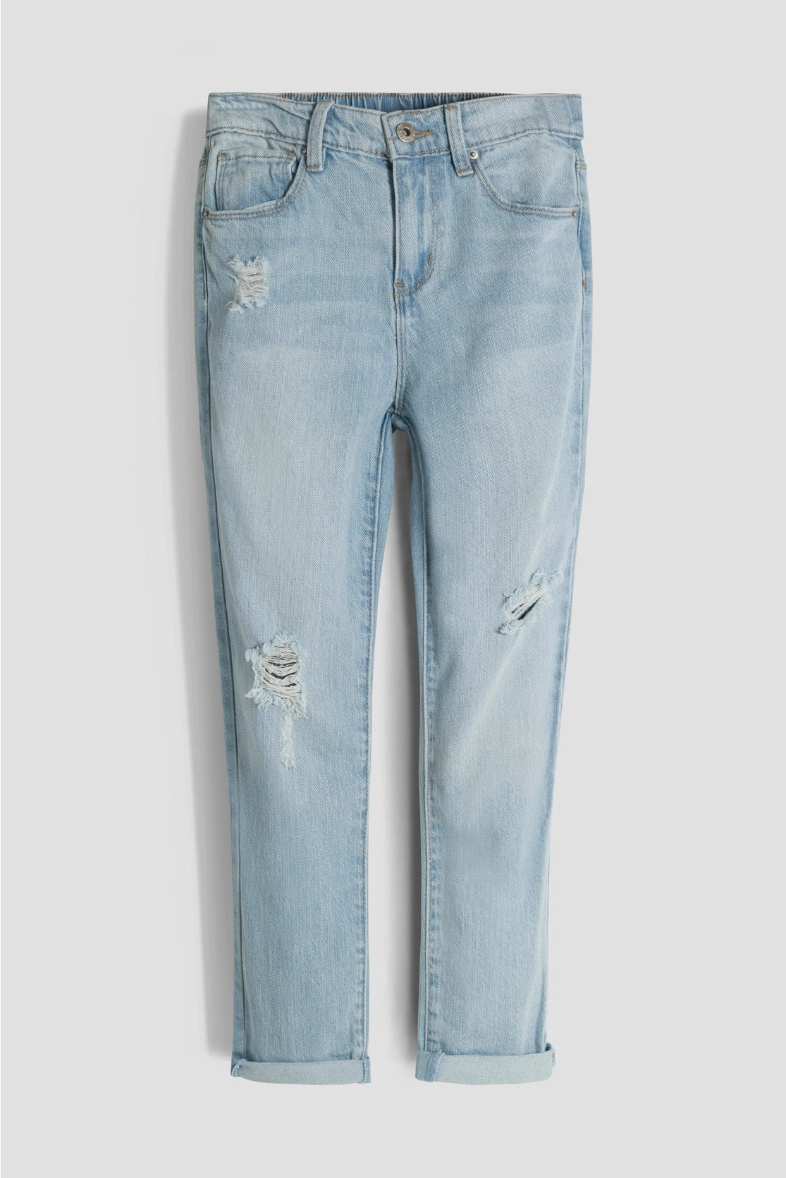 Light blue jeans with slight distressing on a white background
