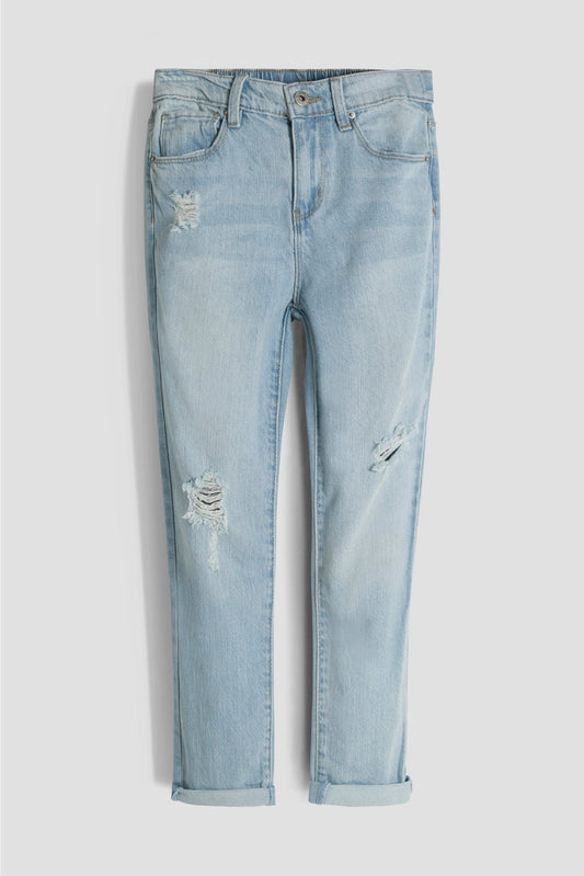 Light blue jeans with slight distressing on a white background