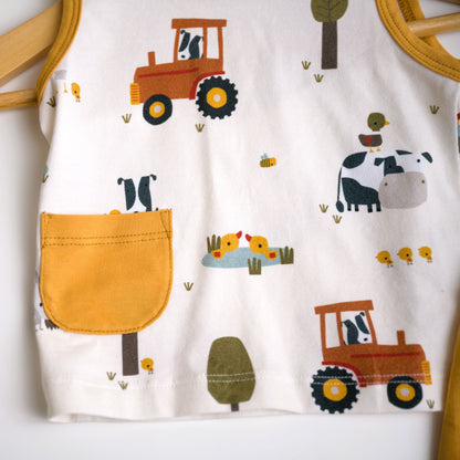 Viverano Organics baby playsuit set with a farm animal print, including a sleeveless tee and shorts in orange, with a white sash tie at the waist.