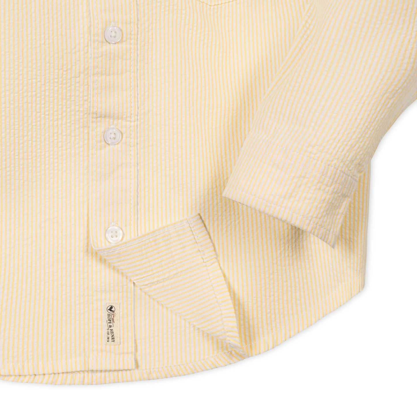 Button view of yellow 100% organic cotton seersucker short sleeve shirt for boys by Hope and Henry.
