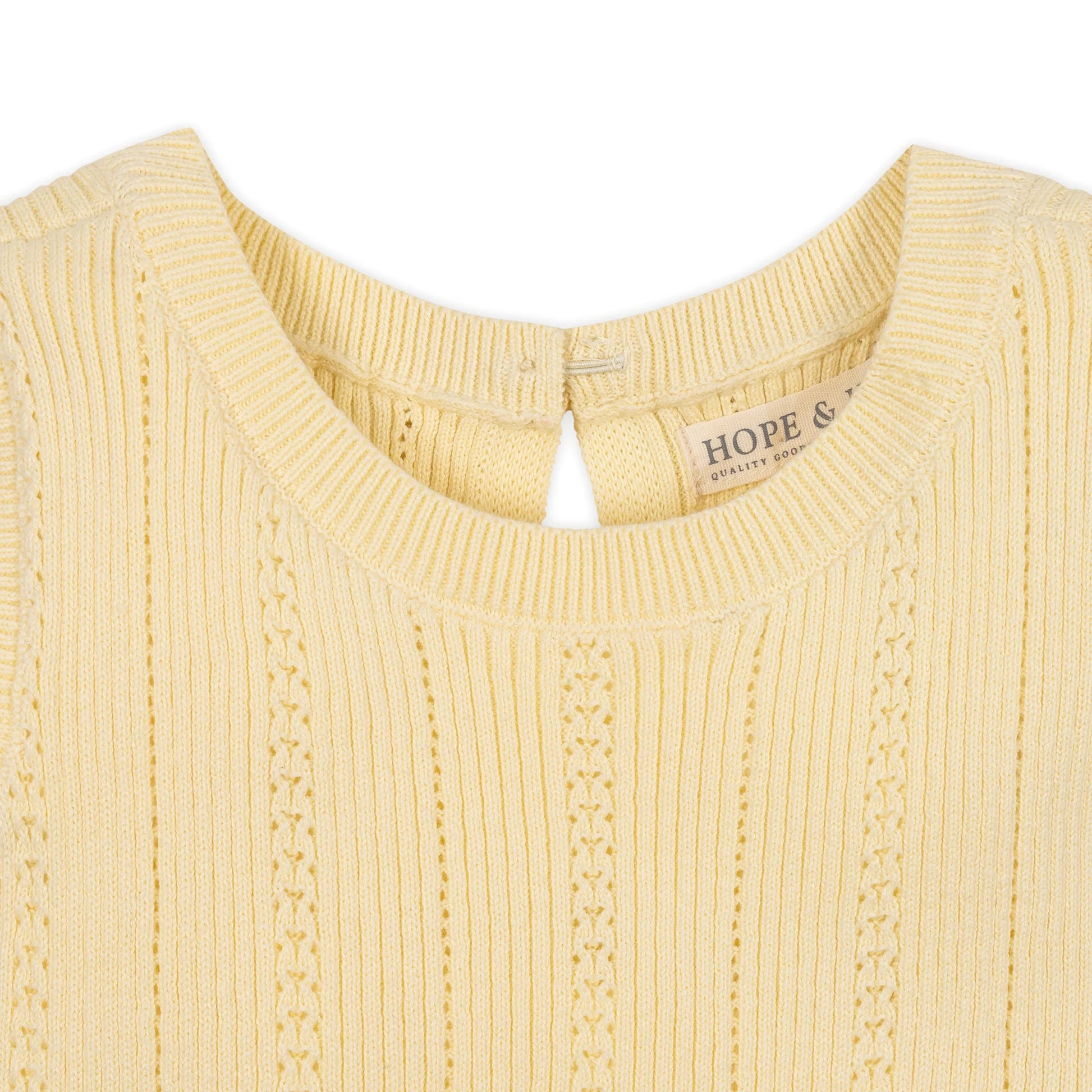 collar view of Yellow organic cotton knit sweater dress for girls with a flounce hem by Hope and Henry.