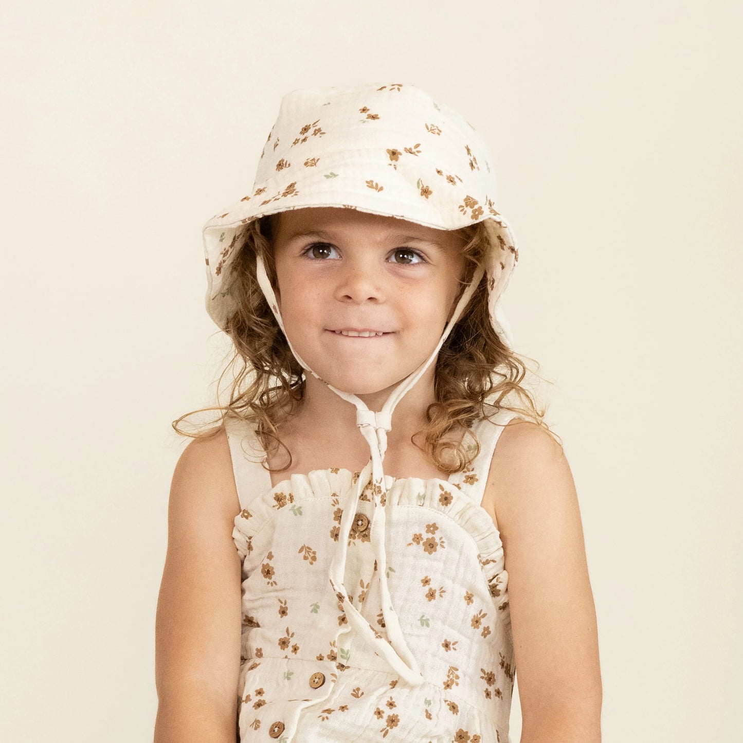 child wearing Makemake Organics Bohemia bucket sun hat with wide brim