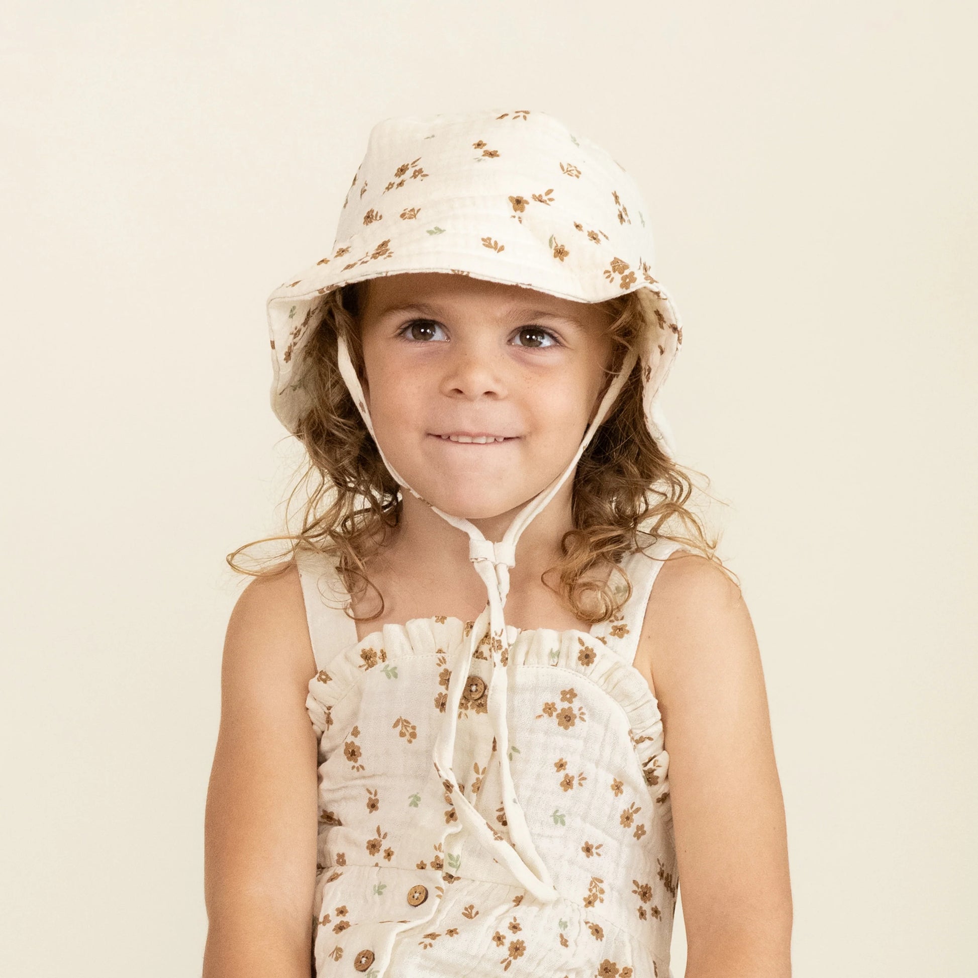 child wearing Makemake Organics Bohemia bucket sun hat with wide brim