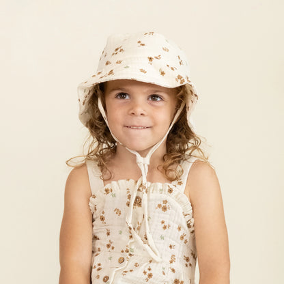 child wearing Makemake Organics Bohemia bucket sun hat with wide brim