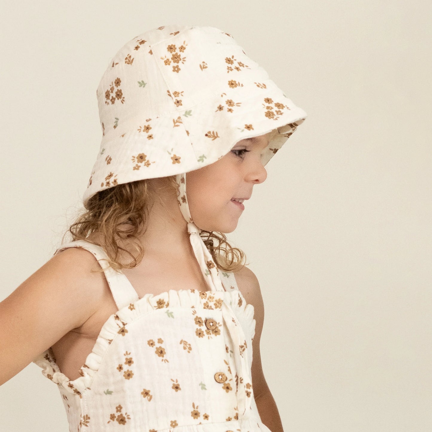 child wearing Makemake Organics Bohemia bucket sun hat with wide brim
